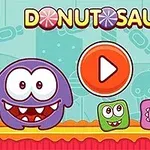 Zaslonska slika videoigre Donutsaur 2 z barvitimi pošastmi in gumbom za predvajanje