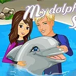 Mladi par drži delfina v akvariju na promocijski sliki za igro My Dolphin Show 2